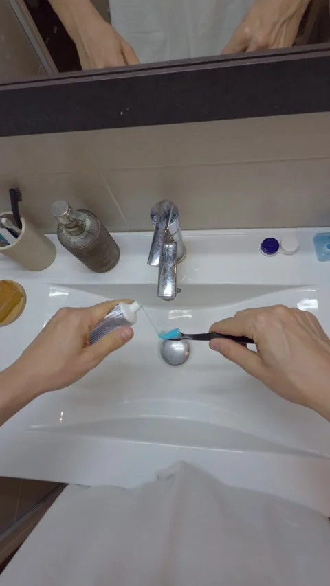 Man squeezing toothpaste on brush in bathroom sink pov Stock-Footage 341039114