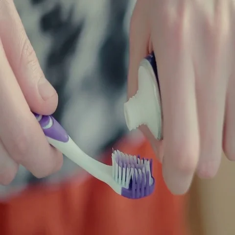 Man squeezing toothpaste on the brush Stock Footage 69438992