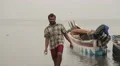 Man from Sri Lanka walking with fish in his hands HD Footage