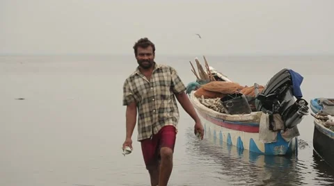 Man from Sri Lanka walking with fish in his hands Stock Footage 49365677
