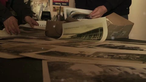 Man with a Stack of Old Photographs. Video stock 112485670