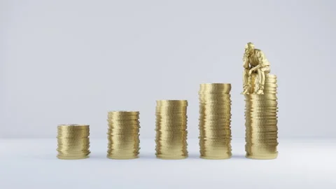Man on Stacked Coins Stock Footage 264512321