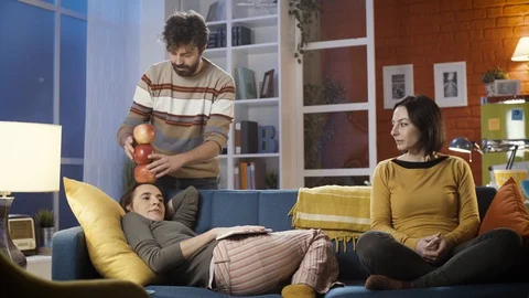 Man stacking apples on his friend's head Stock Footage 128778198
