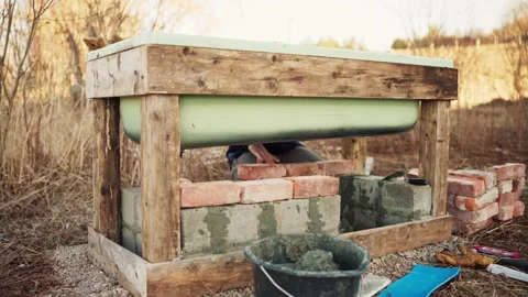 The Man is Stacking Bricks Beneath the DIY Hot Tub - Timelapse Stock Footage 266244778