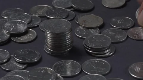 Man Stacking up coins. Dark Background. Finance Concept Stock Footage 260168161