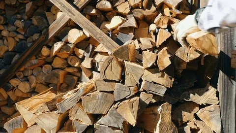 Man Stacking Firewood into Cords to be used as an Alternative Fuel Source Stock Footage 84237877