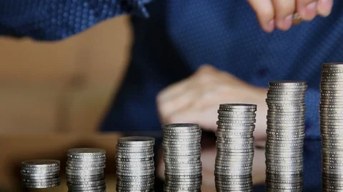 Man stacking up some coins Stock Footage 129175400