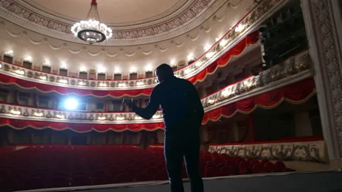 Man on stage on classical theater hall background. Stock Footage 147085371