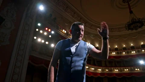 Man on stage gesticulating and talk. Professional actor performing his role  Stock Footage 149924404