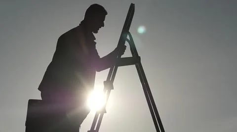 Man on stairs with case going up slow motion silhouette Stock Footage 59982424