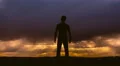 The man stand against the background of sunset. Time lapse. Wide angle 4k or 4k+ Resolution