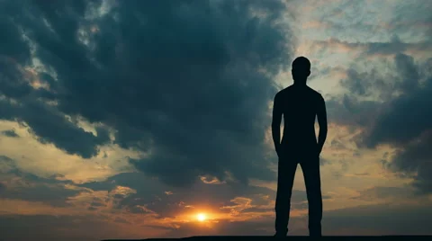 The man stand against the move sunset cloud. Time lapse. Wide angle Vidéo 61777276