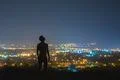The man stand on the background of the city lights. night time Photo