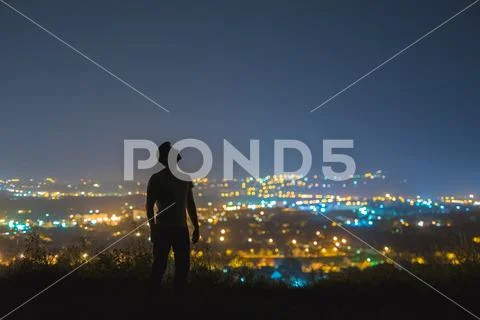 The man stand on the background of the city lights. night time Stock Photos