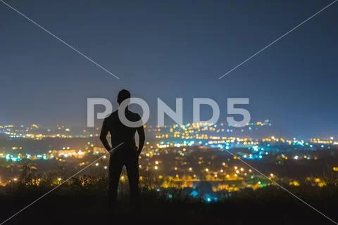 The man stand on the background of the city lights. night time Stock Photos