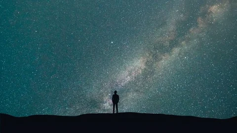 The man stand on a background of a milky way with asteroids skyfall. time lapse Stock Footage 78920938