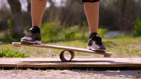 A man stand on a balancing board Stock Footage 107537614