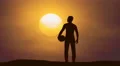 The man stand with a ball against the background of sunset. Time lapse 4k or 4k+ Resolution