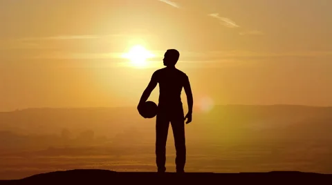 The man stand with a ball on the background of sunset. Time lapse Stock Footage 61216699