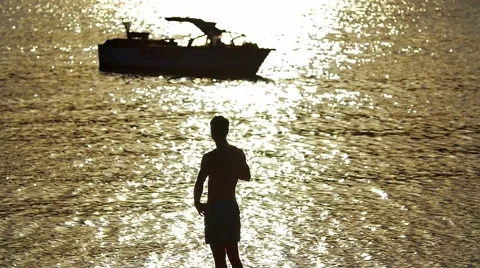 Man stand on the beach, dream and rest by boat and bright sunlight reflection Video stock 55230554