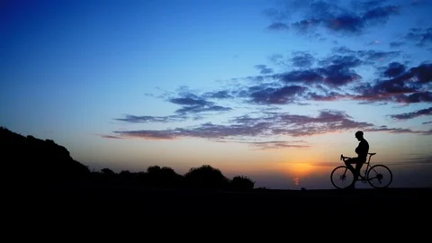 The man stand with a bicycle against the background of sunset. time lapse Stock Footage 96584644