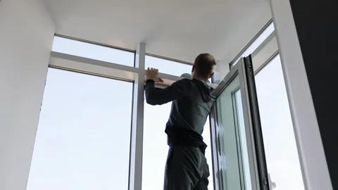 Man stand on border of window on wash it with Stock Footage 299667867