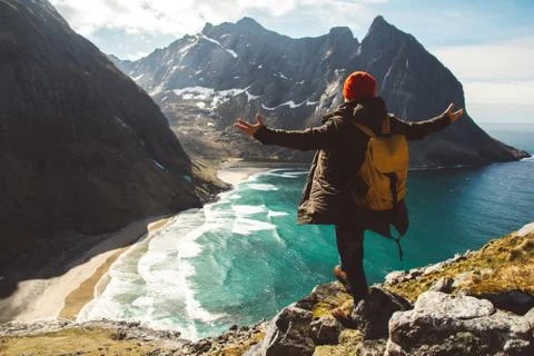 Man stand on cliff edge alone enjoying aerial view backpacking lifestyle trav Stock Photos