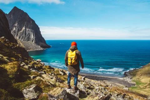 Man stand on cliff edge alone enjoying aerial view backpacking lifestyle trav Stock Photos