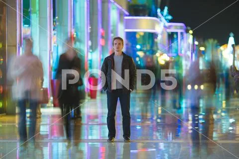 The man stand in the color alley. Evening night time Stock Photos