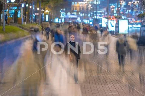 The man stand in crowd flow. Evening night time Stock Photos