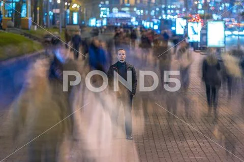 The man stand in crowd stream. Evening night time Stock Photos