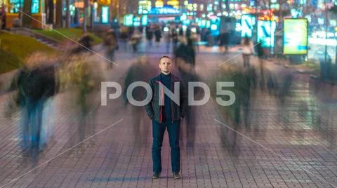 The man stand in crowd stream. Evening night time Stock Photos