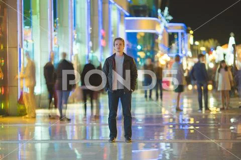 The man stand in the crowd stream. Evening night time Stock Photos