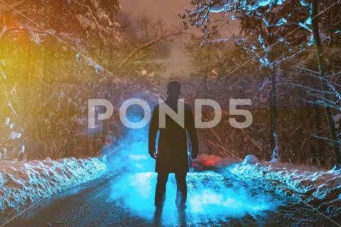 The man stand on a forest road on the smoke background. evening night time Stock Photos