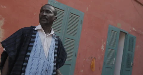 Man stand in front of his house, Goree, Senegal (4K) Stock Footage 47942838