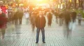 Man stand in ghost crowd stream. sunset on sunrise light flare seen. time lapse 4k or 4k+ Resolution