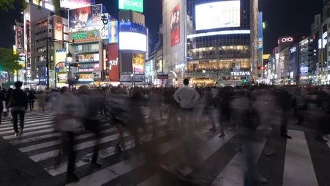 Man stand in middle of running crowd, time lapse shot of Shibuya crossing Stock Footage 128080494