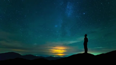 The man stand on mountain top on a starry sky background. time lapse Stock Footage 160125142