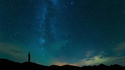 The man stand on mountain top on a starry sky background. time lapse Stock Footage 160125235