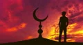The man stand near the Islam symbol against the background of sunset. Real time 4k or 4k+ Resolution