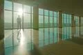The man stand near the panoramic window on the background of sunrise Photo