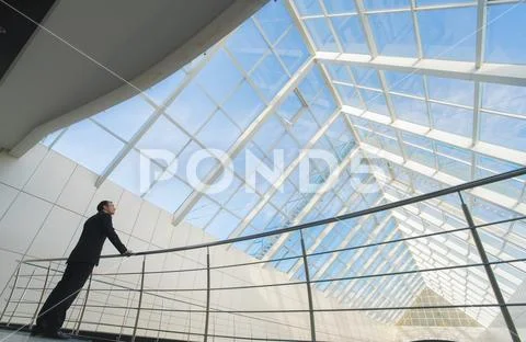 The man stand near railing on the office balcony Stock Photos
