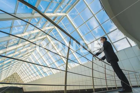 The man stand near railing on the office balcony Stock Photos