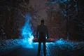 The man stand near the smoke in the winter forest. evening night time Photo