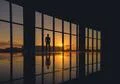 The man stand near the window on a background of sunrise Photo