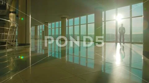 The man stand near the window on the background of sunrise Stock Photos
