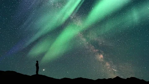 The man stand on a northern light background. time lapse Stock Footage 160124769