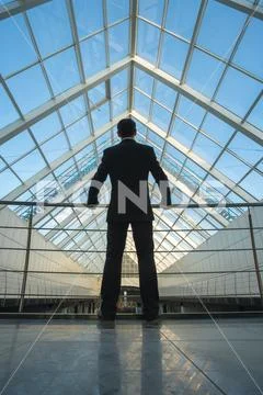The man stand on the office balcony Stock Photos