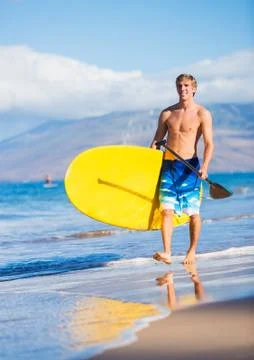 Man with stand up paddle board Stock Photos