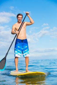 Man on stand up paddle board Stock Photos